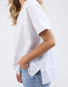 White 100% cotton Allison Tee with a relaxed fit, round neckline, design lines, and raw edge details, offering comfort and effortless style for everyday wear.