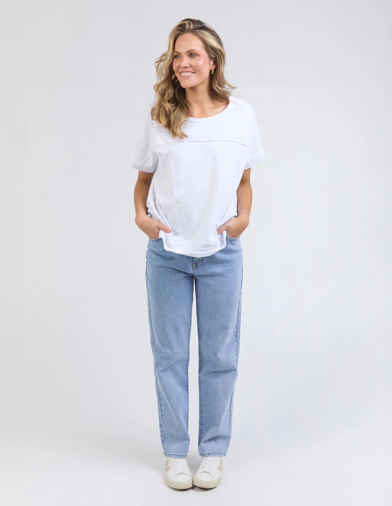 White 100% cotton Allison Tee with a relaxed fit, round neckline, design lines, and raw edge details, offering comfort and effortless style for everyday wear.