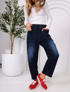 Leo barrel-leg jeans with a fitted waist, relaxed flared mid-leg, and tapered ankle, styled for a laid-back coastal look with a subtle Western-inspired edge.