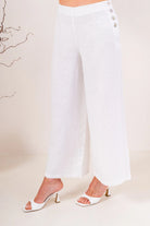 Palazzo linen pants featuring a relaxed wide-leg fit, high waist and shell button detailing down the side seam.