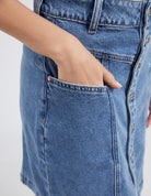 The Blue Eliza Denim Skirt by Elm is currently available at Rawspice Boutique.