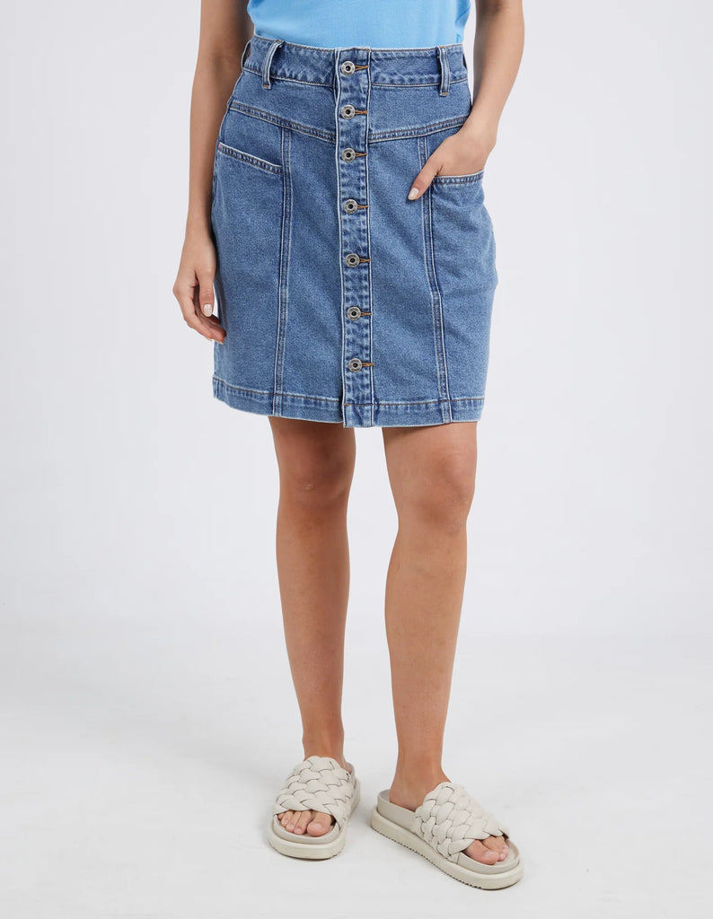 The Blue Eliza Denim Skirt by Elm is currently available at Rawspice Boutique.