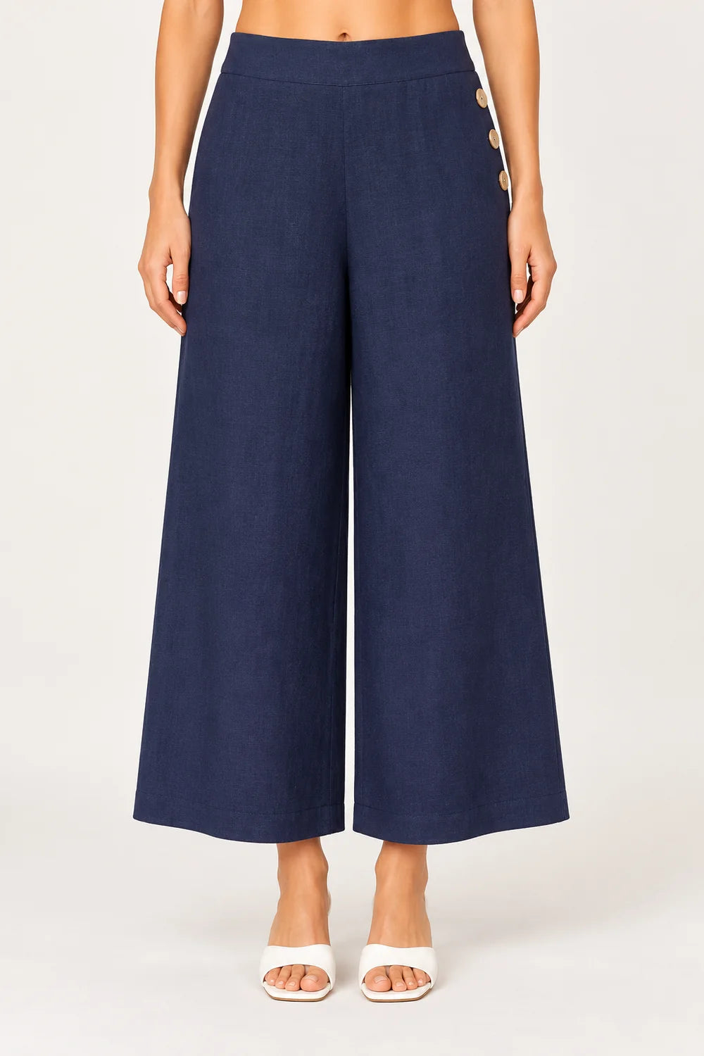 Palazzo linen pants featuring a relaxed wide-leg fit, high waist and shell button detailing down the side seam.