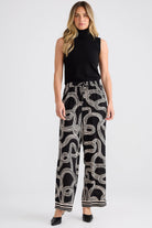 Relaxed straight-leg pants with an elasticated drawstring waistband, cutaway side pockets, lightweight draping fabric, and bold abstract line print.