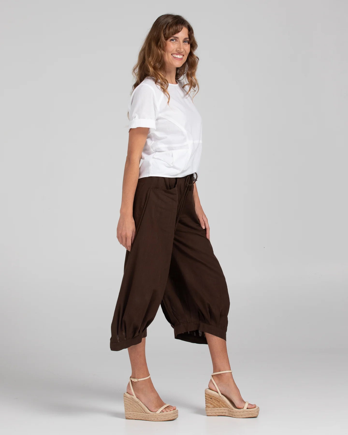 Boom Shankar Guru Pant in Coffee, featuring a relaxed fit with a drawstring waistband, 3/4 length, front and back pockets, and signature seam detailing.