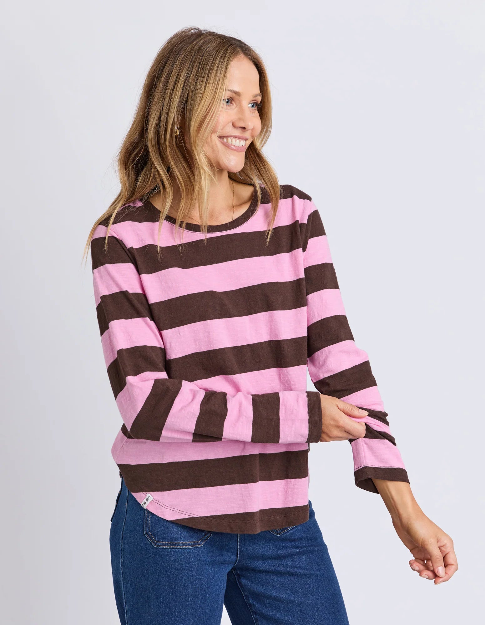 Yarn-dye stripe cotton slub jersey top with a curved hemline, lightweight feel, and relaxed fit ideal for layering.