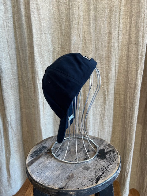 Smiley Cap in Navy with curved brim, adjustable back strap, and embroidered smiley face detail on the front.