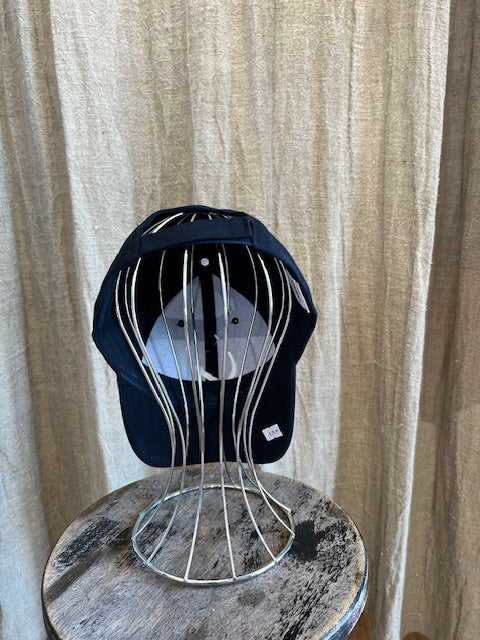 Smiley Cap in Navy with curved brim, adjustable back strap, and embroidered smiley face detail on the front.