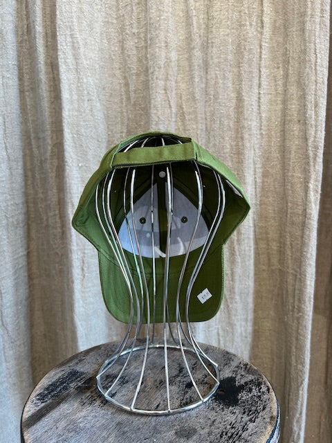 Smiley Cap in Olive with curved brim, adjustable back strap, and embroidered smiley face detail on the front.