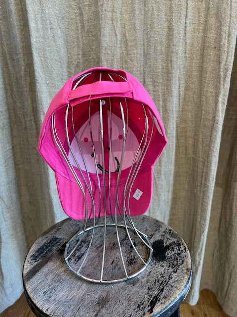 Smiley Cap in Pink with curved brim, adjustable back strap, and embroidered smiley face detail on the front.