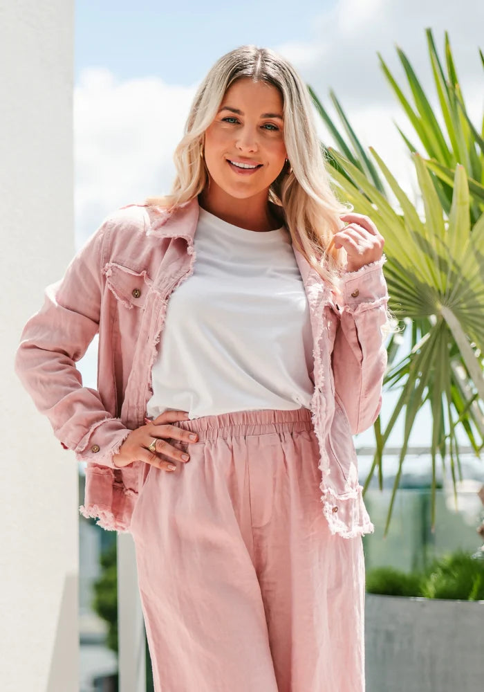 A woman wearing a pink linen Julia Fray jacket by Soul Sparrow