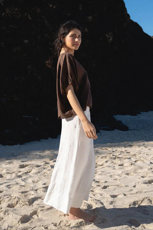 The Lily Pilly Tina Top in chocolate linen is designed with a relaxed silhouette, lightweight feel, and natural textured weave.