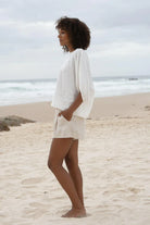 The Lily Pilly Tina Top in soft ivory linen features a relaxed silhouette, breathable lightweight fabric, and naturally textured weave.