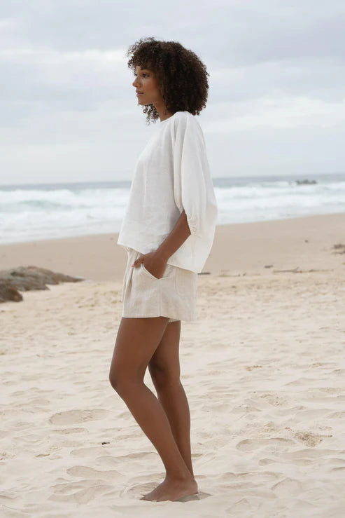 The Lily Pilly Tina Top in soft ivory linen features a relaxed silhouette, breathable lightweight fabric, and naturally textured weave.
