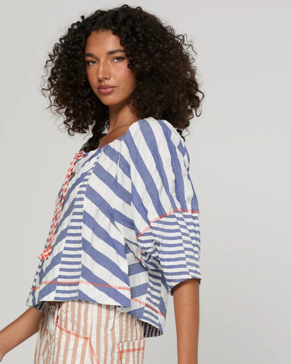 Boom Shankar Lucia Top in Ocean Stripe featuring chevron stripe panelling, balloon sleeves, contrast cuffs and an adjustable tie neckline.