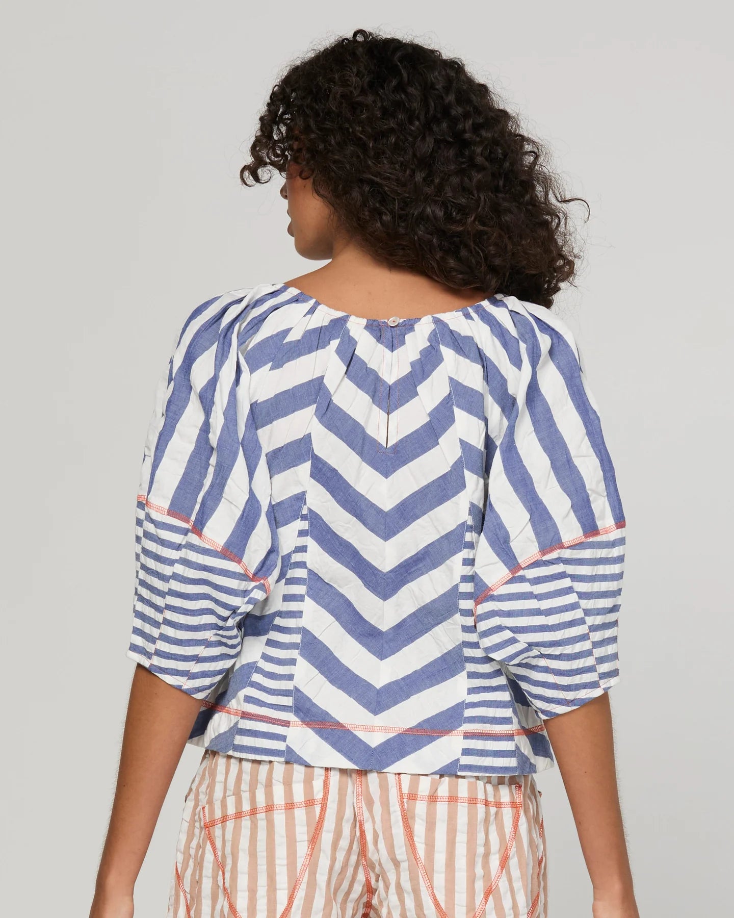 Boom Shankar Lucia Top in Ocean Stripe featuring chevron stripe panelling, balloon sleeves, contrast cuffs and an adjustable tie neckline.