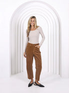 Model wearing relaxed-fit corduroy barrel jeans with a flattering silhouette, featuring front and back pockets for a modern, everyday look.