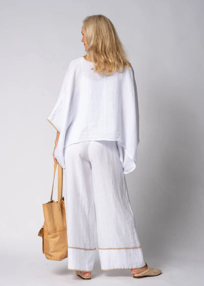 The Mireya Linen Top in White. Relaxed, button-up linen blouse with raw-stitched neckline, styled for warm-weather versatility.