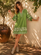 Olivine Shift Dress in 100% linen featuring floral embroidery, V-neckline, 3/4 shirred sleeves and a classic knee-length silhouette.