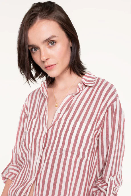 Boyfriend linen shirt in rhubarb stripe, designed with a relaxed fit, French seams, tab sleeves, and a flattering scoop hem. Crafted for comfort and effortless style.