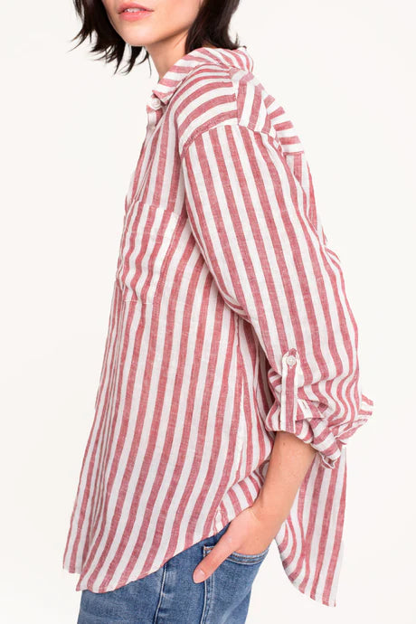 Boyfriend linen shirt in rhubarb stripe, designed with a relaxed fit, French seams, tab sleeves, and a flattering scoop hem. Crafted for comfort and effortless style.