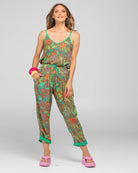 Boom Shankar Rimi Pant in vibrant Rimini print, featuring a contrast Verde waist tie, elasticated gathered waistband, side pockets, and cuffed hems with button and tab detailing.