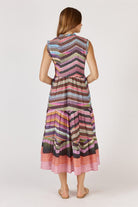 A flowing maxi dress made from a textured check-weave cotton-nylon blend, featuring a round neckline with delicate frill detailing and sleeveless armholes with matching frill trims. The shirred bodice offers a flattering, fitted shape, while the relaxed A-line skirt falls to mid-calf for an elegant, easy drape. Functional pockets add practicality to this feminine, effortless design