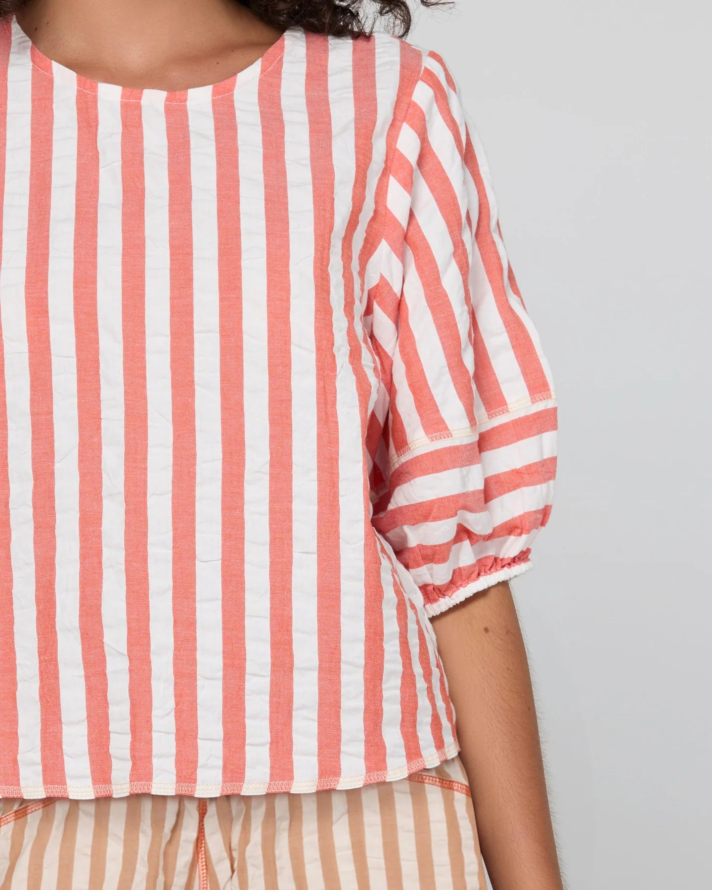 Boom Shankar Ava Top in Watermelon Stripe featuring coral and white stripes, elbow-length puff sleeves, a round neckline and cropped length.