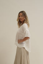 White combo Barbara linen top with a relaxed fit, breathable mesh panels and soft stonewashed texture.