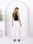 Model wearing Toni barrel-leg jeans with a fitted waist, relaxed curved leg shape, and tapered ankle for a modern coastal Western-inspired look.