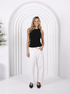 Model wearing Toni barrel-leg jeans with a fitted waist, relaxed curved leg shape, and tapered ankle for a modern coastal Western-inspired look.
