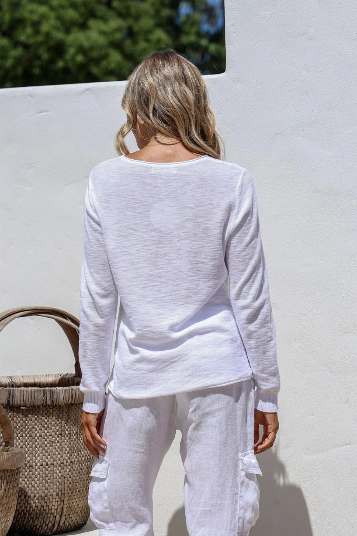 White 100% cotton light knit top with a breathable, timeless design, ideal for layering or wearing alone for everyday comfort and style.