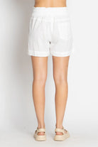 White cotton beach shorts with a relaxed fit and elastic waistband
