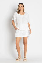 White cotton beach shorts with a relaxed fit and elastic waistband