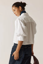 Beth Shirt in White crafted from 100% cotton, featuring short sleeves, a relaxed true-to-size fit, and a clean, versatile design for everyday wear.