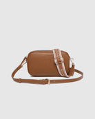 Bianca Crossbody Bag in tan vegan leather with zip closure, light gold hardware, and adjustable crossbody strap displayed front view.
