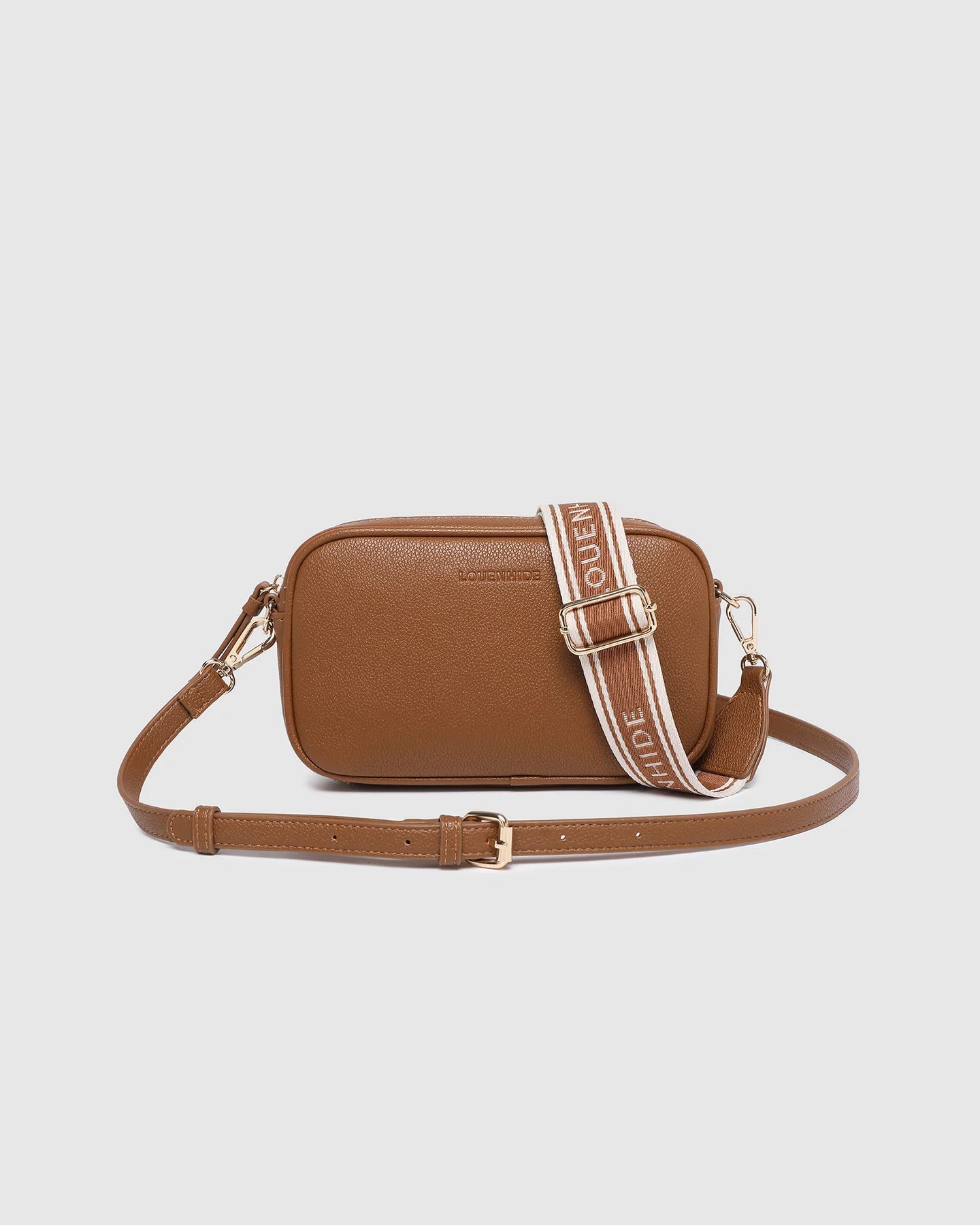 Bianca Crossbody Bag in tan vegan leather with zip closure, light gold hardware, and adjustable crossbody strap displayed front view.
