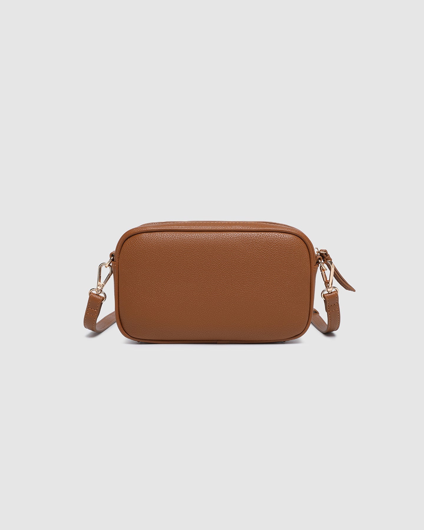 Bianca Crossbody Bag in tan vegan leather with zip closure, light gold hardware, and adjustable crossbody strap displayed front view.
