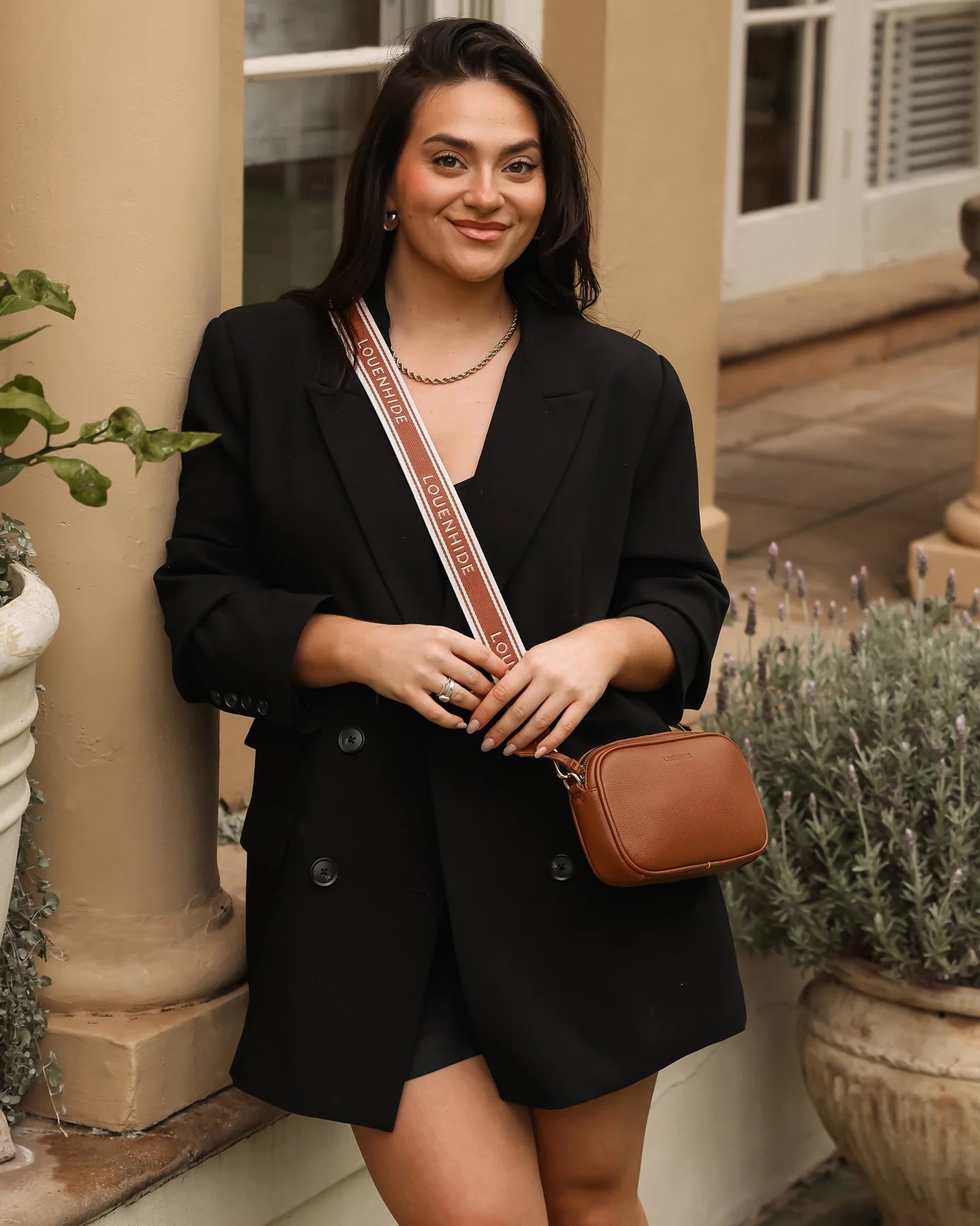 Bianca Crossbody Bag in tan vegan leather with zip closure, light gold hardware, and adjustable crossbody strap displayed front view.
