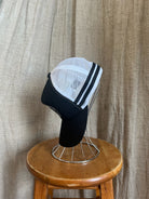 Rocks Hat in black featuring a whale tail design on the front, snapback closure, and breathable mesh sides for a comfortable, adjustable fit.