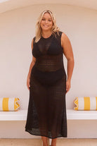 Black Maxi Mesh Dress – sleeveless, form-fitting longline beach cover-up with a high neckline, perfect for layering over swimwear by the beach or pool.