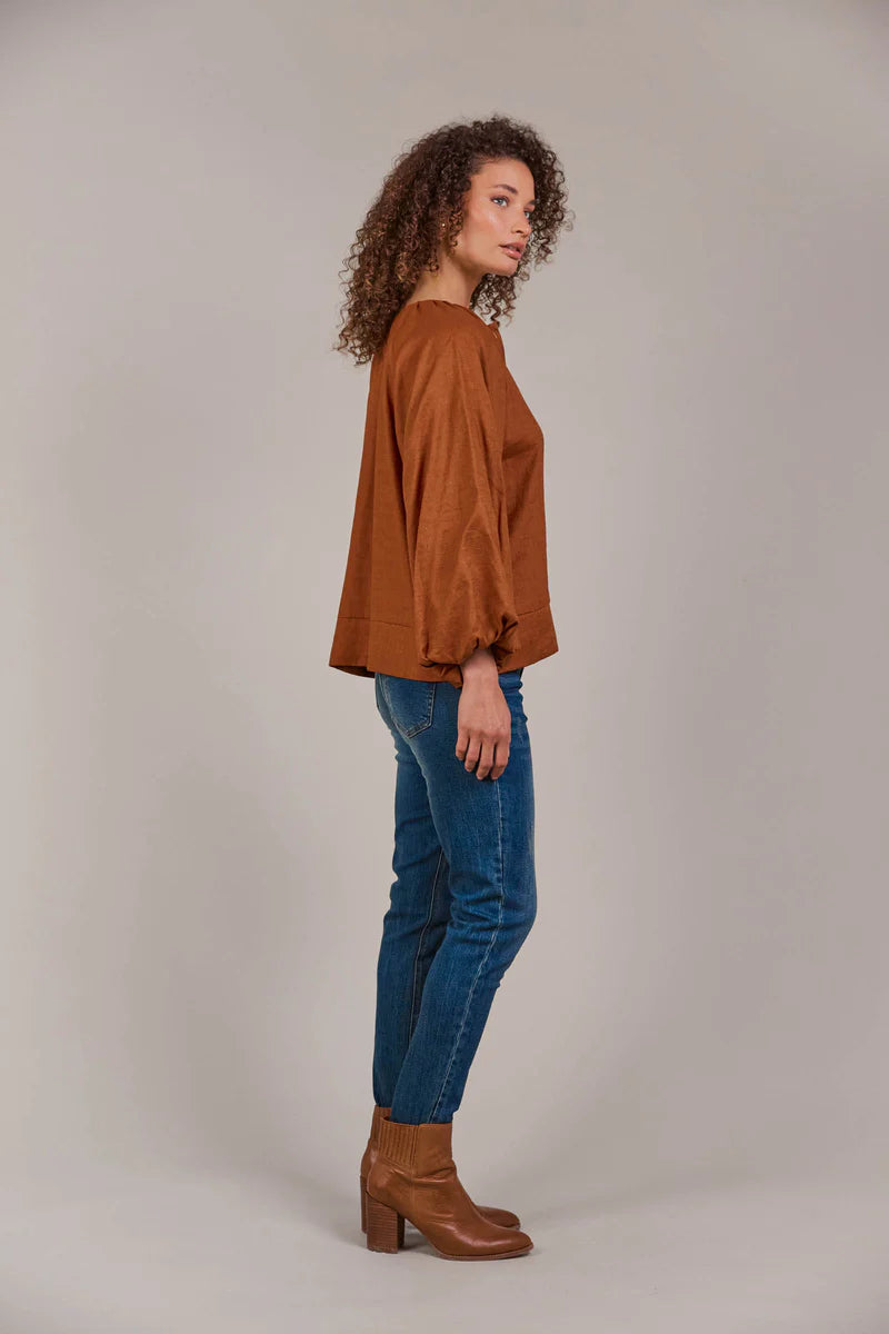 Hazel linen-cotton blend blouse with a collarless neckline, voluminous bishop sleeves, and a relaxed, hip-length silhouette for a stylish, contemporary look.