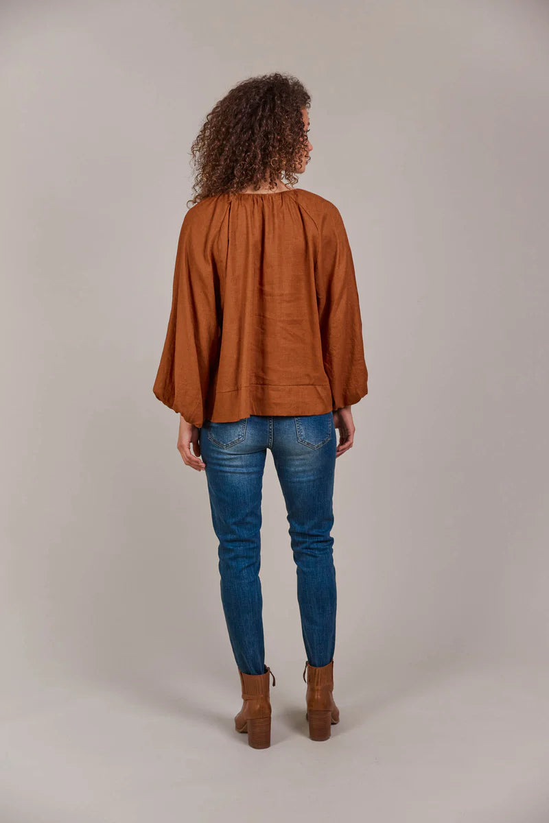Hazel linen-cotton blend blouse with a collarless neckline, voluminous bishop sleeves, and a relaxed, hip-length silhouette for a stylish, contemporary look.