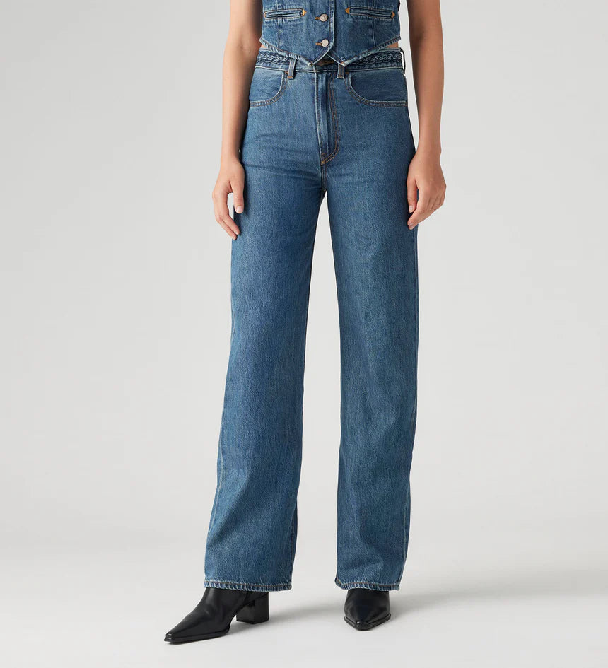 Women's Ribcage Wide Leg Braided Jeans, a high-rise, wide-leg denim with a braided waist detail, designed to define the waist and elongate the legs.