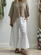 The White Bruna Button Wide Legged Pants by Rustic Linen are currently available at Rawspice Boutique.