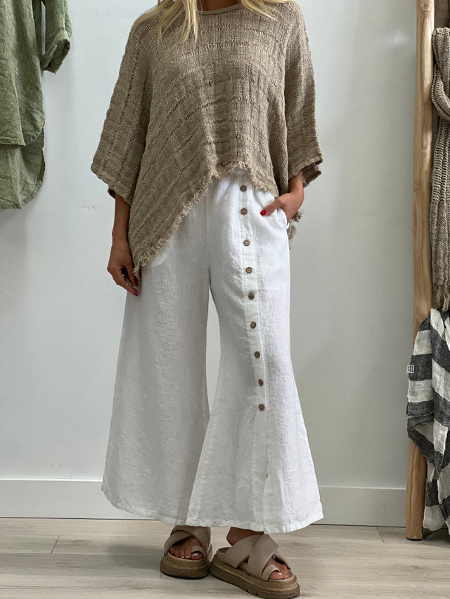 The White Bruna Button Wide Legged Pants by Rustic Linen are currently available at Rawspice Boutique.