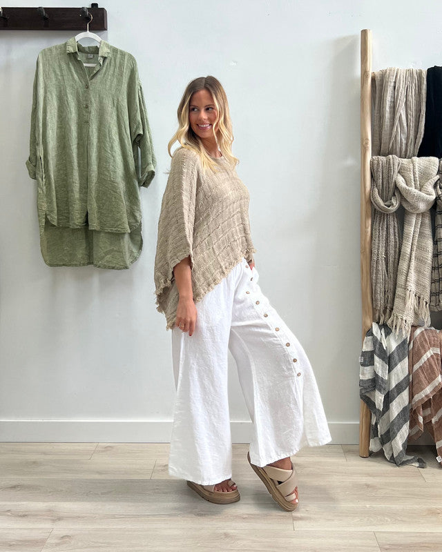 The White Bruna Button Wide Legged Pants by Rustic Linen are currently available at Rawspice Boutique.