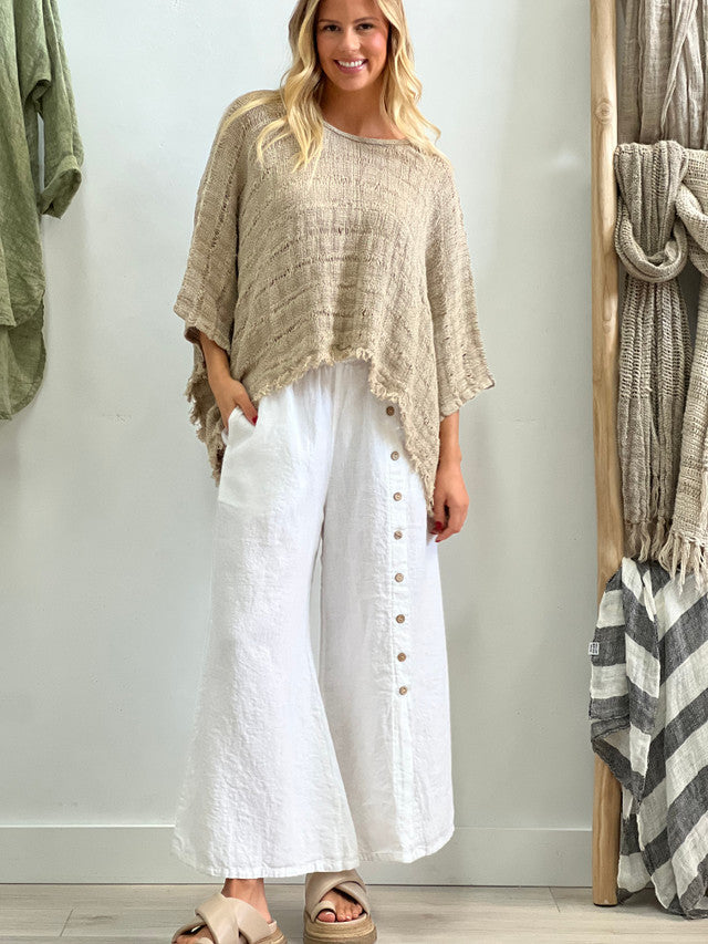 The White Bruna Button Wide Legged Pants by Rustic Linen are currently available at Rawspice Boutique.