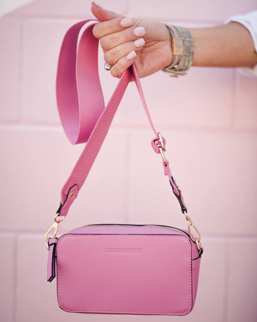 The Rubix Crossbody Bag in Bubblegum Pink by Louenhide is currently available at Rawspice Boutique.
