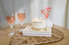 Meeraboo Gold Lid Soy Candle in a clear glass vessel with a brushed gold lid and double wicks, hand-poured with soy wax for long-lasting fragrance.
